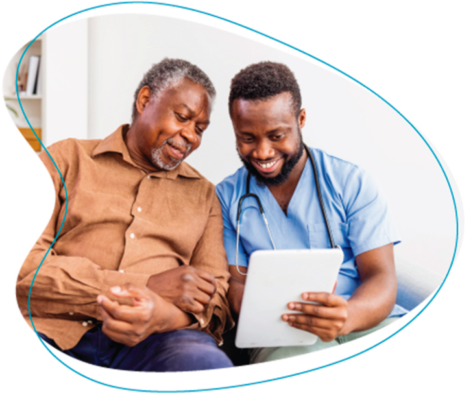 banner_phpp Young doctor is meeting with an older male patient and they are viewing a tablet.